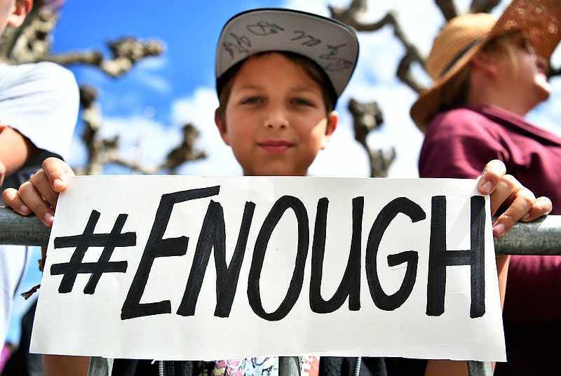 Zachary Chakin holds up a sign as crowds of people participate in the March for Our Lives rally in support of gun control, Saturday, March 24, 2018, in San Francisco. In a historic groundswell of youth activism, hundreds of thousands of teenagers and their supporters rallied across the U.S. against gun violence Saturday, vowing to transform fear and grief into a "vote-them-out" movement and tougher laws against weapons and ammo. (AP Photo/Josh Edelson)