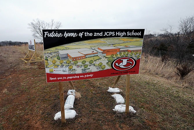 Capital City High School's sign is seen along Missouri 179 at Mission Drive. Architects have altered the new school's design to reduce the building's footprint, reducing excavation costs.