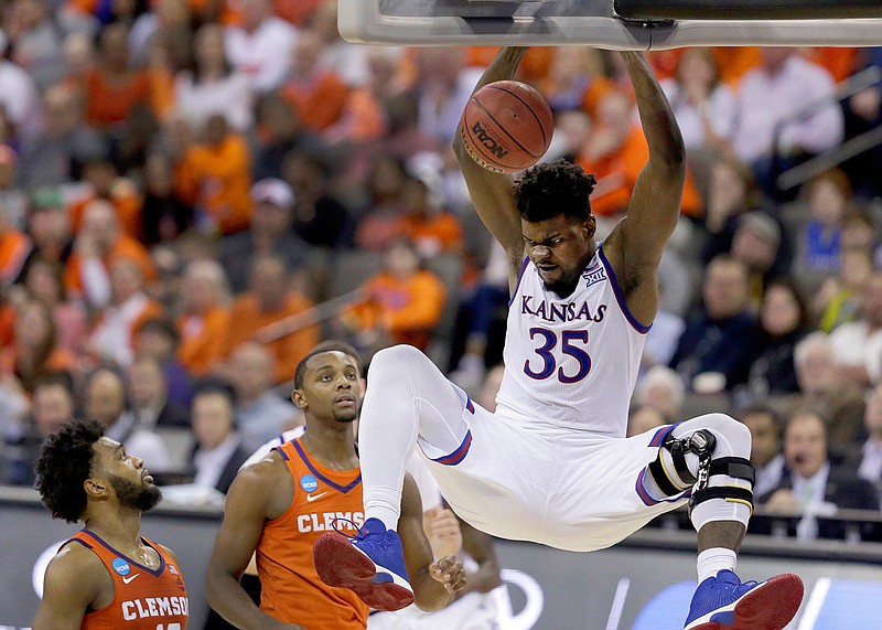 Kansas' Udoka Azubuike (35) dunks as Clemson's Gabe DeVoe, left, and Aamir Simms watch during the second half of a regional semifinal game in the NCAA men's college basketball tournament Friday, March 23, 2018, in Omaha, Neb. Kansas won 80-76. (AP Photo/Charlie Neibergall)