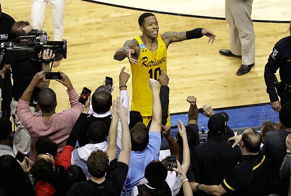 UMBC's Jairus Lyles (10) celebrates with fans after the team's 74-54 win against Virginia earlier this month in a first-round game of the NCAA Tournament in Charlotte, N.C.