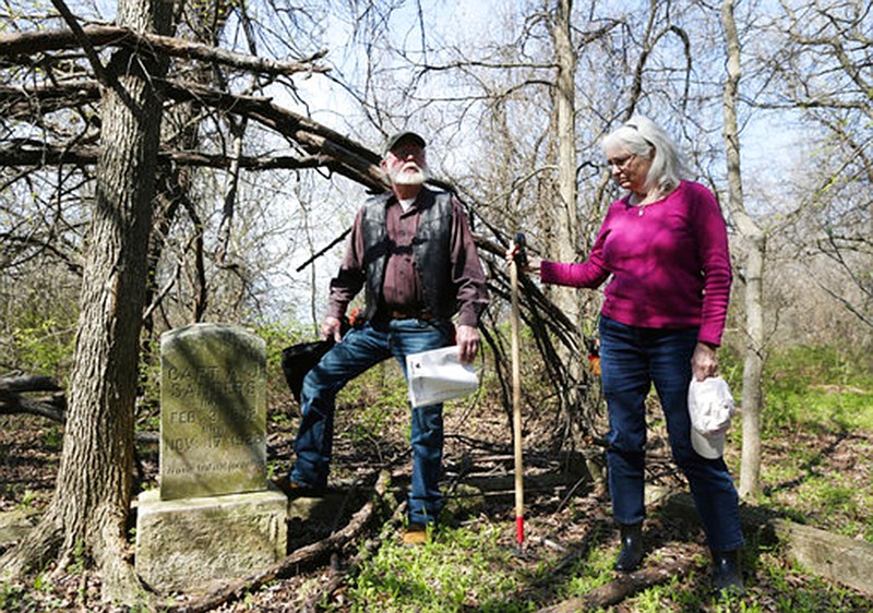 John Kamenec and Rita Ballentine Hogan stand next to a headstone March 14 in the New Zion Cemetery near Downsville, Texas. The cemetery is one of 240 in the county they have mapped in the past two years.