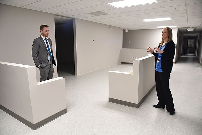 Kyra Clevenger, left, director of compliance, and Jeff Davis, CEO of Community Health Center of Central Missouri, talk about the health center's upcoming move into the new location at 1511 Christy Drive. Construction is still underway, but soon the office personnel, doctors and nurses will be moving into the building.