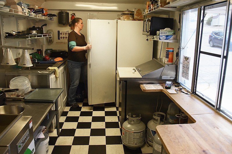 Emil Lippe/HER Magazine
Denise Schubert gathers food to prepare following the Battle for the Badges at The Bridge inside REO Feedwagon on Saturday, March 24, 2018. Schubert and her fiance, Jerry.