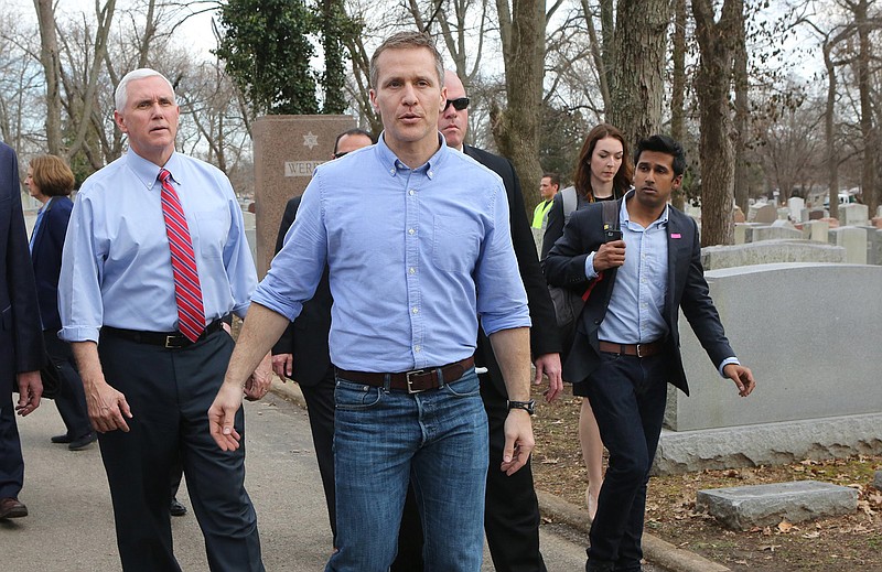 Vice President Mike Pence and Missouri Gov. Eric Greitens walk through the Chesed Shel Emeth Cemetery in University City, Mo., on Wednesday, Feb. 22, 2017, after viewing some of the damage done last weekend when more than 150 headstones were overturned. (J.B. Forbes/St. Louis Post-Dispatch/TNS) 