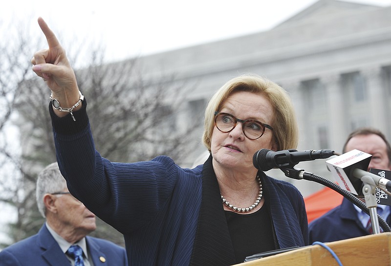 U.S. Sen. Claire McCaskill points to the Missouri Supreme Court building as she refers to her presumed opponent, Attorney General Josh Hawley, in the upcoming race for her congressional seat. She and other elected officials addressed an estimated 2,500 supporters of union labor on hand Wednesday, March 29, 2018, for the rally at the state Capitol to oppose right-to-work legislation. 