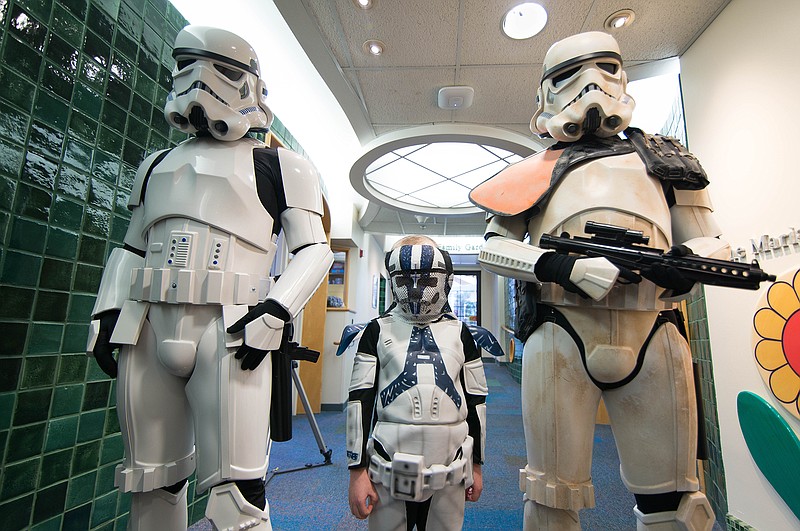 <p>Submitted photo</p><p>Evan Cornett, an 8-year-old boy from Eldon, stands with stormtroopers in his “Star Wars” clone trooper costume and proton beam therapy mask painted like a clone trooper helmet.</p>