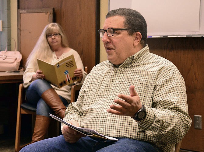 Robert Pinhero moderates the "Coming to America: Immigration Forum" on Thursday at the Missouri River Regional Library. The discussion centered on the issue of immigration. In the background is Charlie German.
