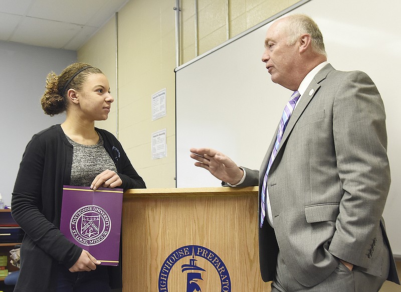 J. Michael Pressimone, president of Fontbonne University, right, delivered the Presidential Scholarship from Fontbonne to Ariona Batiste, a senior at Lighthouse Preparatory Academy on March 23 during a visit to the west end Jefferson City school. 