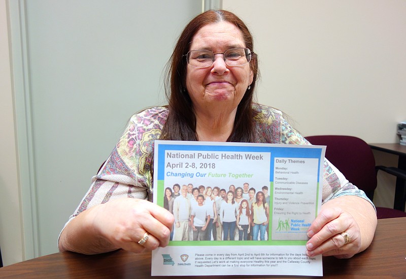 <p>Helen Wilbers/For the News Tribune</p><p>Sharon Lynch, director of the Callaway County Health Department, holds a topic schedule for public health week. Other upcoming events include the Mommy and Baby Fair on April 14 and a community discussion meeting April 12.</p>
