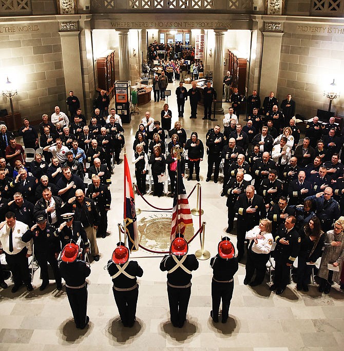 First responders from across Missouri gathered Wednesday at the Capitol for Firefighters Day, an annual event in which the importance of fire service is recognized and highlighted. Here they stand for the Pledge of Allegience as members of the Columbia Fire Department's Honor Guard stand before them with a Missouri and United States flag. Missouri has more than 850 fire departments, both professional and volunteer, that features more than 24,000 responders. Most of the visitors wore their dress uniforms to the day's activities, which featured brief speeches from Gov. Eric Greitens, Department of Public Safety Director Drew Juden and Missouri Fire Marshal Tim Bean.