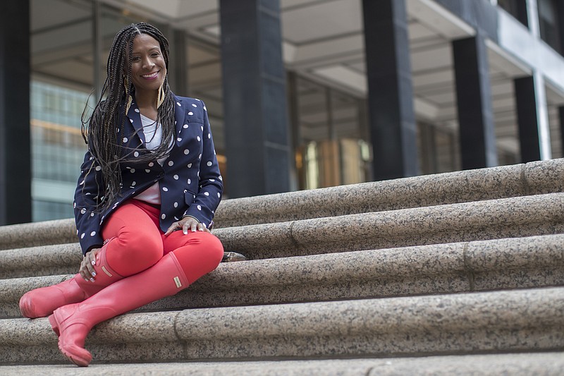 In this Wednesday, April 4, 2018 photo, Arlene Pitterson poses for a photo in New York. Council-member Rafael Espinal has proposed legislation that would bar employers from requiring employees to check and respond to non-emergency emails, texts and other electronic communications sent outside of regular work hours, or retaliating against them if they didn’t. The bill would be intended to make life better for people like Pitterson, a marketing and event planning consultant in Brooklyn, who recalled one boss routinely pestering her with late-night emails, then grew upset when she didn’t reply. (AP Photo/Mary Altaffer)