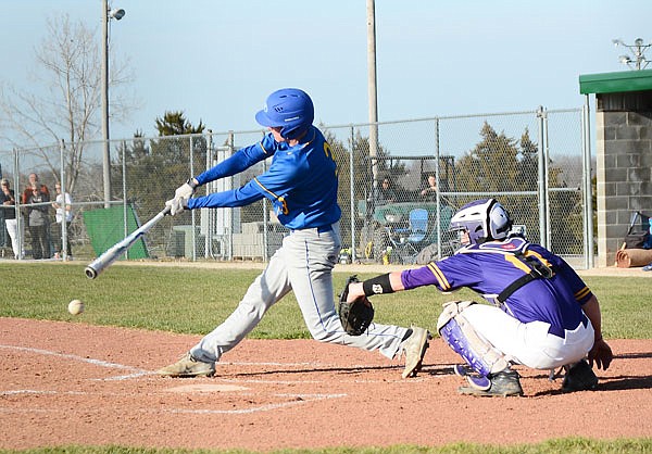 Fatima's Trey Herzing makes contact on a pitch during Thursday's game against Hickman in the Capital City Invitational at the American Legion Post 5 Sports Complex.