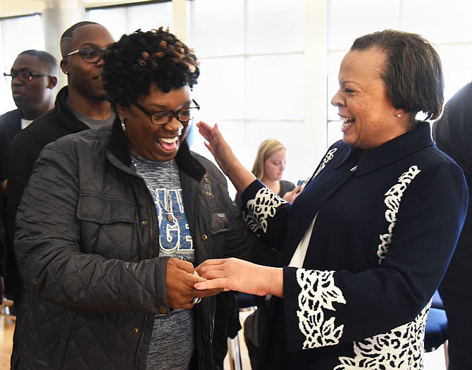 New Lincoln University President Dr. Jerald Jones Woolfolk, right, shares a laugh with Marnita Brown following Woolfolk's introductory meeting Friday as the new Lincoln University president in the Scruggs University Center Ballroom.