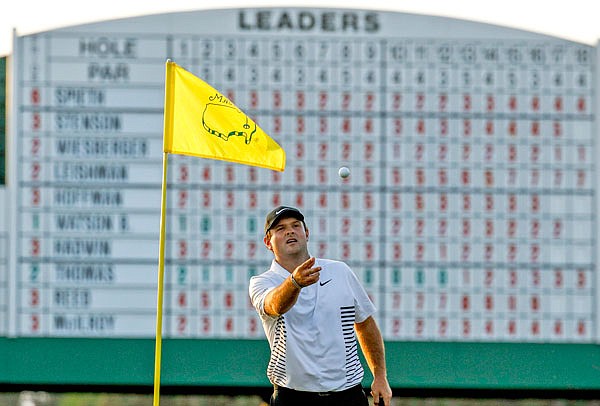 Patrick Reed catches a ball on the 17th green during the second round Friday at the Masters in Augusta, Ga.