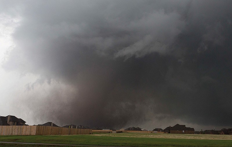 In this Monday, May 20, 2013 file photo, a tornado moves past homes in Moore, Okla. (AP Photo/Alonzo Adams. File)