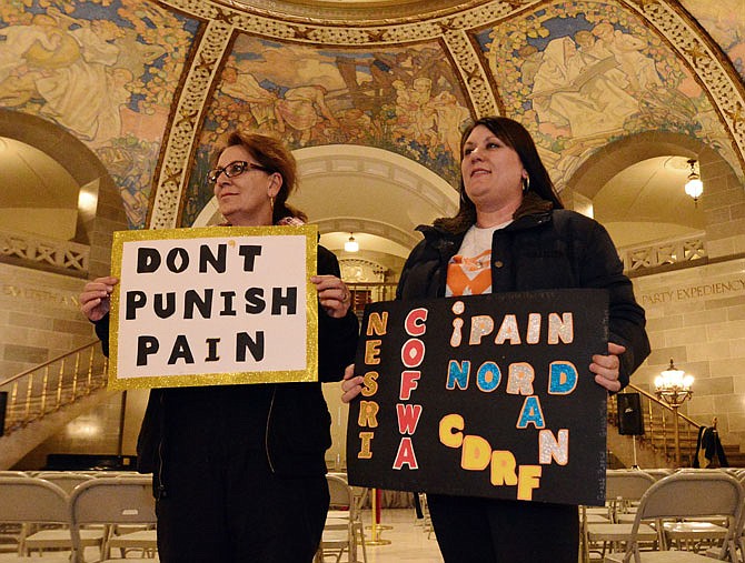 Lacy Fowler, right, a chronic pain sufferer, is joined by her mother, Marsha Hutchison, for the Don't Punish Pain rally Saturday at the Capitol. 