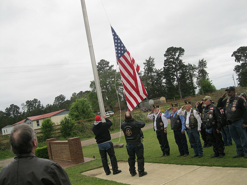 Local and area military veterans raise the U.S. flag Saturday during the official grand opening of the new location of Lancer Legacy Ranch near Maud, Texas. The flag was the same one that draped the coffin of U.S. Army Specialist Robert T. Hendrickson, who died in combat April 4, 2004, during a ground battle in Sadr City, Iraq, during Operation Iraqi Freedom.