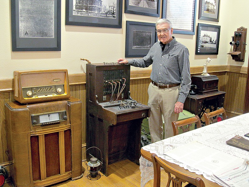 DeWayne Hardage, Three Bostons Museum board president, stands near an early-20th century telephone operator's connection desk now on display at the museum. The desk is just one of many historical artifacts that have been collected and donated to the museum.