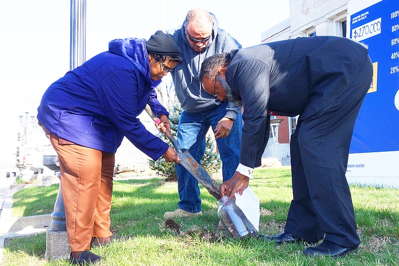 <p>Helen Wilbers/For the News Tribune</p><p>Anna Braxton, left, president of the Fulton chapter of the NAACP; NAACP member Webster Davi; and Missouri NAACP President Nimrod Chapel dig up soil in front of the Callaway County courthouse on Saturday. The courthouse served as the site of the second hanging of Emett Divers, an African-American man lynched in Fulton in 1895.</p>