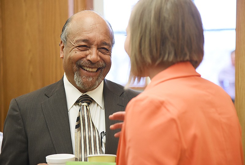 Jefferson City Public School Board Member Michael Couty cracks a smile Monday while talking with a colleague at a reception before the start of a school board meeting at the JCPS Board of Education Building.