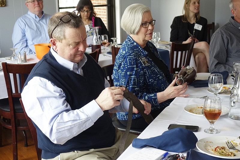 <p>Jenny Gray/FULTON SUN</p><p>Bruce Hackman checks out a quiver while Susan Krumm, holding a leather flask, listen to a talk about a recent trip to Tanzania at this week’s Fulton Rotary lunch.</p>