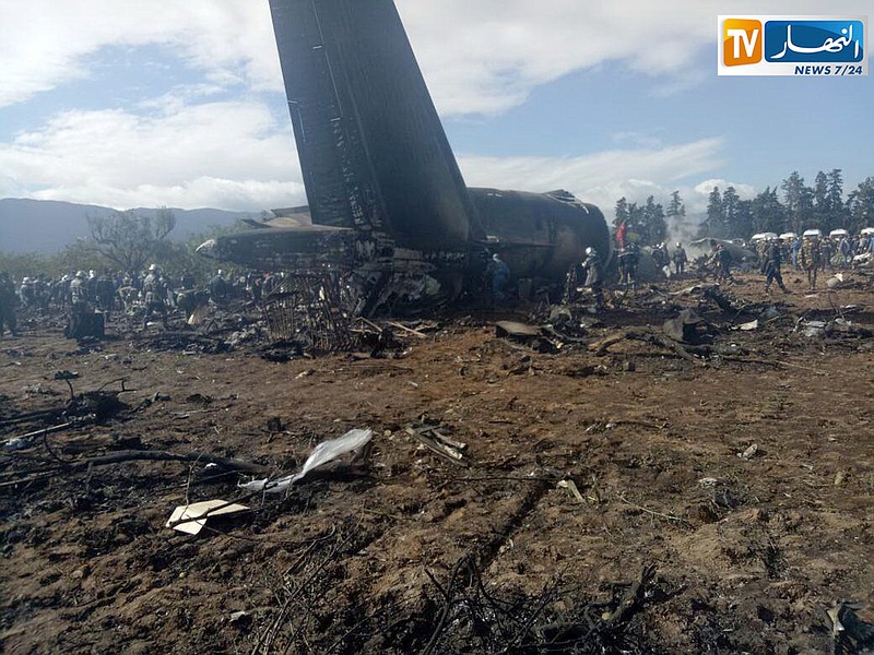 In this image dated Wednesday, April 11, 2018, and released by Algerian TV agency Ennahar TV, shows firefighters and civil security officer at the scene of a fatal military plane crash at Boufarik military airbase, near the Algerian capital, Algiers. An Algerian military plane carrying soldiers and their families crashed soon after takeoff Wednesday into a field in northern Algeria, killing 257 people in what appeared to be the North African nation's worst-ever plane crash. (Ennahar TV via AP)