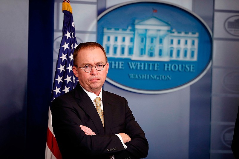 In this Jan. 20, 2018, file photo, Director of the Office of Management and Budget Mick Mulvaney stands during a press briefing at the White House in Washington. Mulvaney, appointed acting director of the Consumer Financial Protection Bureau in November, promised to shrink the bureau's mandate and take a much softer approach to enforcement, and records reviewed by The Associated Press indicate he has kept his word. (AP Photo/Alex Brandon, File)