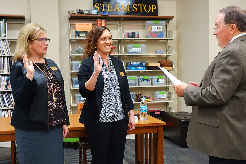 <p>Helen Wilbers/FULTON SUN</p><p>New Fulton Public Schools Board of Education members Jackie Pritchett, left, and Leah Baker are sworn in Wednesday by Superintendent Jacque Cowherd. Verdis Lee Sr. was selected as the board president, Andy Bonderer as vice persident and Emily Omohundro as secretary.</p>