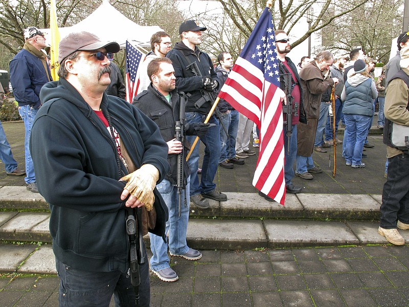 This Feb. 8, 2013 file photo shows pro-gun demonstrators at a rally outside the state Capitol in Salem, Ore. Organizers are encouraging gun rights supporters to bring unloaded weapons to rallies at state capitols across the U.S. this weekend of April 14, 2018, to counter a recent wave of student-led protests against gun violence. (AP Photo/Jonathan J. Cooper, File)