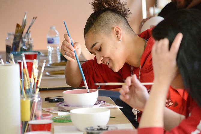 In this April 2018 photo, Ashton Napier, a student at the Jefferson City Academic Center, paints a bowl at Capital Arts in advance of the Empty Bowl Luncheon. Students and teachers from the alternative school paint bowls included in the luncheon to raise money for the Salvation Army. 