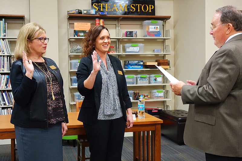 New Fulton Public Schools Board of Education members Jackie Pritchett, left, and Leah Baker are sworn in Wednesday by Superintendent Jacque Cowherd. Verdis Lee Sr. was selected as the board president, Andy Bonderer as vice persident and Emily Omohundro as secretary.