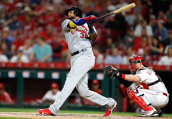 Jose Martinez of the Cardinals watches his solo home run off Reds relief pitcher Zack Weiss during the seventh inning of Thursday night's game in Cincinnati.