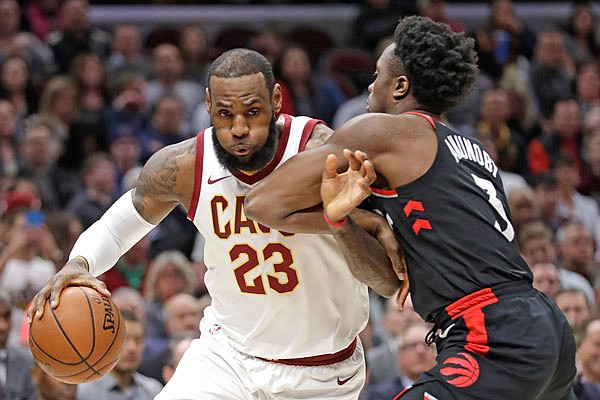 OG Anunoby of the Raptors defends LeBron James of the Cavaliers in the first half of a game earlier this month in Cleveland. The Raptors are the top seed in the Eastern Conference while the Cavaliers are the No. 4 seed.