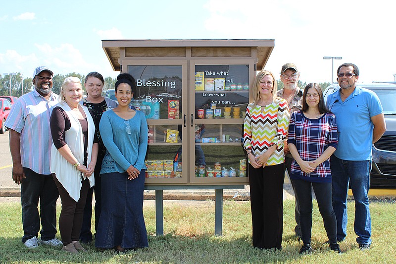 Husqvarna employees organized the Blessing Box to provide toiletry items such as 
deodorant, toothpaste, shampoo, soap, toilet paper, bottled water and canned foods to people in need. The photo includes, from left, Keith Young, Belinda Broyles, Kristie Skinner, Ammi Perez, Tina McBay, Rex Icenhower, Mindy Bowman and L.A. King  (Submitted photo)
