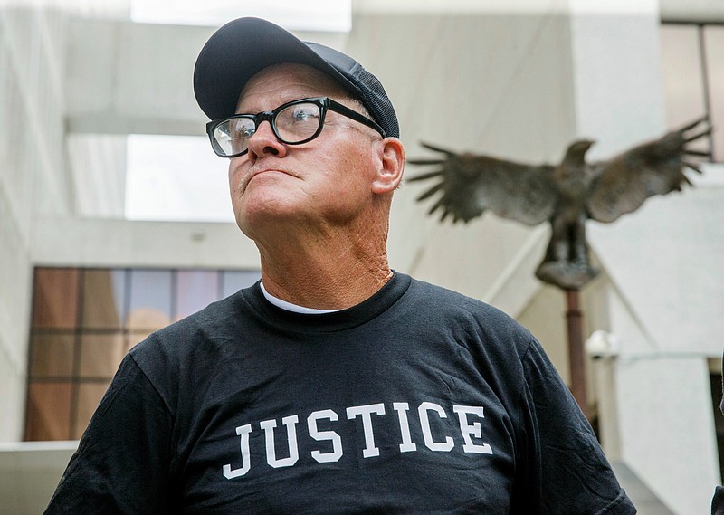 FILE - In this June 22, 2017 photo, John Floyd stands in front of the Hale Boggs Federal Building and Courthouse in New Orleans. Floyd was freed last year after spending 36 years locked up for a New Orleans murder he insisted he didn’t commit.  A federal appeals court this month upheld a U.S. District judge’s decision to order a new trial for Floyd, who said a detective coerced him to confess to the 1980 slaying. (AP Photo/Sophia Germer, File)