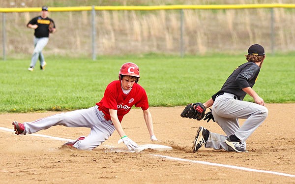 Ian MacLaughlin of Calvary Lutheran slides into third base past Vienna third baseman Brenden Hollis during the first inning of Friday afternoon's Calvary Lutheran/New Bloomfield Tournament game at Calvary Lutheran.