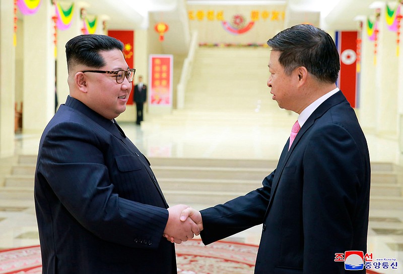 In this April 14, 2018, photo provided Sunday, April 15, 2018, by the North Korean government, North Korean leader Kim Jong Un, left, shakes hands with Song Tao, head of the Chinese Communist Party Central Committee's international department in North Korea. North Korean leader Kim met the high-ranking Chinese diplomat, amid a flurry of diplomacy following Kim's surprise visit to Beijing. Independent journalists were not given access to cover the event depicted in this image distributed by the North Korean government. The content of this image is as provided and cannot be independently verified. Korean language watermark on image as provided by source reads: "KCNA" which is the abbreviation for Korean Central News Agency. (Korean Central News Agency/Korea News Service via AP)
