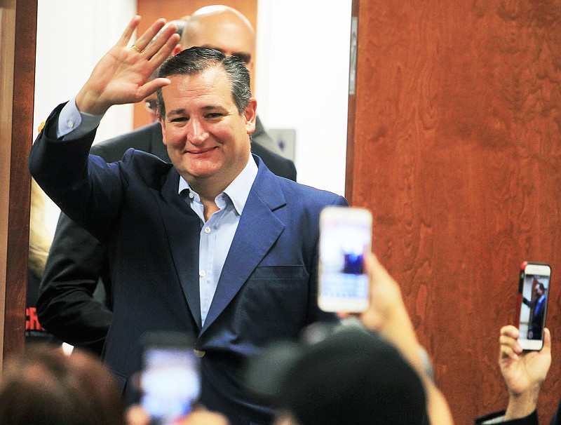 FILE - In this April 2, 2018, file photo, U.S. Senator Ted Cruz, R-Texas, waves to supporters as he enters the room while campaigning for re-election at the National Border Patrol Council Local 3307 offices in Edinburg, Texas.  The Texan is seeking re-election to the U.S. Senate by pledging to repeal Barack Obama’s signature health care law, abolish the IRS and beat back federal overreach, even though the Trump administration has already diluted the health law, delivered sweeping tax cuts and code revisions and controls Washington along with a Republican-led Congress. (Joel Martinez/The Monitor via AP, File)