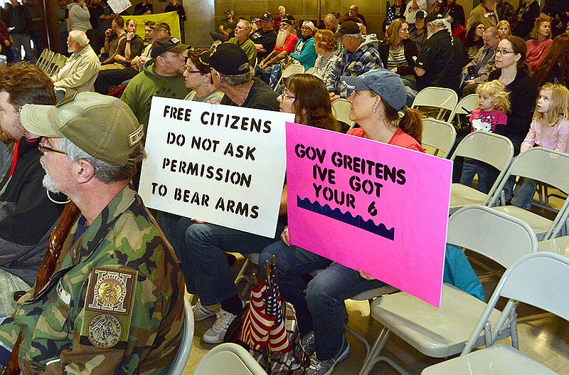 Dee Ann Poole, right, and Vicky Gibson display their signs Saturday during the "Americans for America" pro-Second Amendment rally at the Capitol. The event was sponsored by the National Constitutional Coalition of Patriotic Americans.