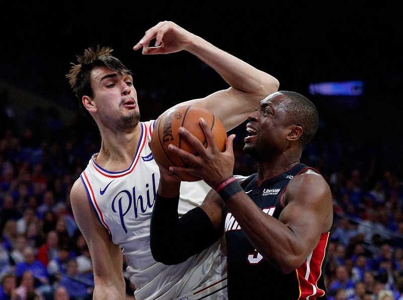 Miami Heat's Dwyane Wade, right, makes his move against Philadelphia 76ers' Dario Saric, left, during the first half in Game 1 of a first-round NBA playoff series Saturday in Philadelphia. 