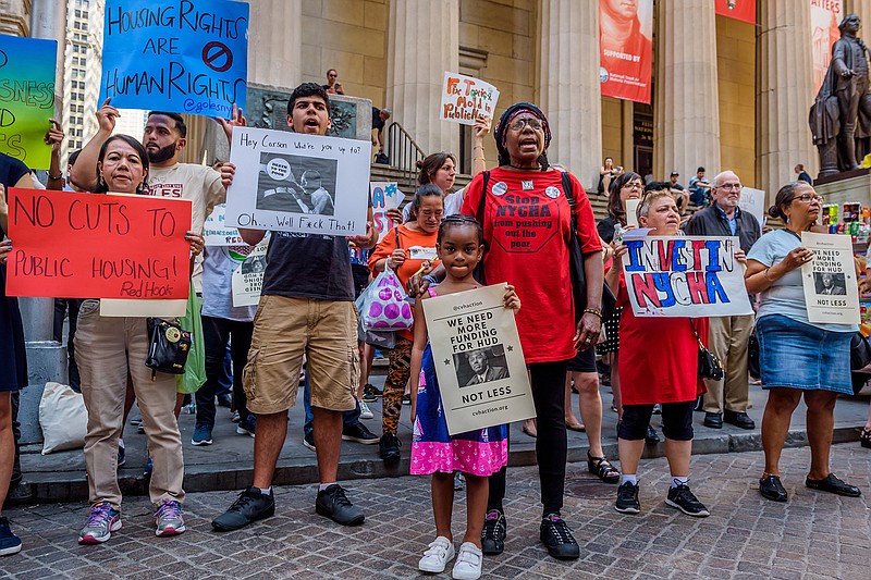  Members of Community Voices Heard protest on Jun 12, 2017, outside the New York Stock Exchange in hopes of meeting with Secretary Ben Carson about proposed HUD cuts.