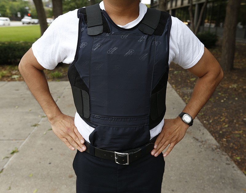 In this Sept. 15, 2014 photo, a Chicago police department cadet models a Second Chance bulletproof vest at the Chicago Police Education and Training Academy in Chicago. Chicago's City Council is watering down its ban on most residents wearing body armor after criticism that it could put in danger people such as 7-Eleven store clerks in crime-ridden neighborhoods. On Wednesday, April 17, 2018, the City Council will vote on the latest revision of an ordinance passed last month to add journalists to the list of people such as police officers, emergency responders and others that are allowed to wear body armor. (Phil Velasquez/Chicago Tribune via AP)