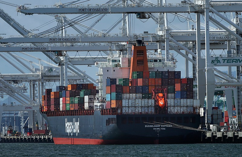 FILE- In this April 12, 2018, file photo, a container ship is unloaded at the Port of Oakland in Oakland, Calif. The International Monetary Fund has upgraded its economic outlook for the United States in 2018 and foresees a strong year for the global economy as well. The IMF predicts that the U.S. economy will grow 2.9 percent this year, up from the 2.7 percent it had forecast in January and up from the 2.3 percent growth the economy achieved last year. (AP Photo/Ben Margot, File)