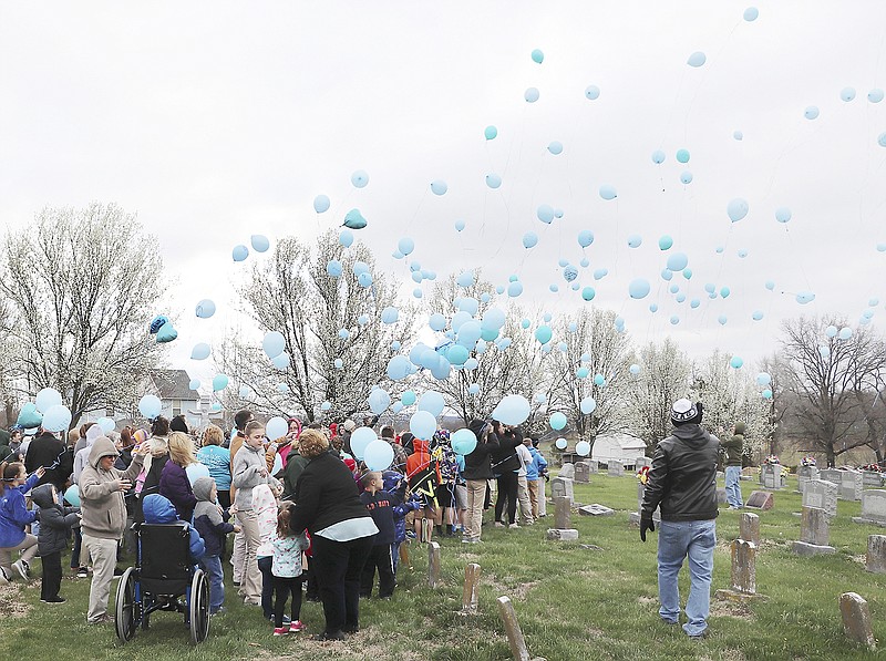 A brief ceremony was held Monday morning at St. Martin Cemetery in remembrance of the one-year anniversary of the death of parish priest, the Rev. Ed. Schmidt. The event featured a balloon launch in which several light blue and white balloons were released into the cold morning air. Schmidt is fondly remembered as a beloved priest who served the parish for 26 years.