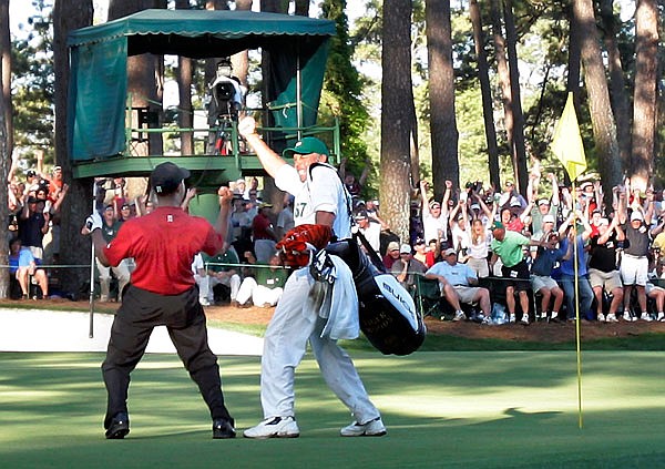 In this April 10, 2005, file photo, Tiger Woods celebrates with his caddie Steve Williams after his chip-in birdie on the 16th hole during the 2005 Masters at Augusta National Golf Club in Augusta, Ga. Jordan Spieth was so inspired by this major and that moment, it was the first shot he wanted to try when he played the Masters for the first time.