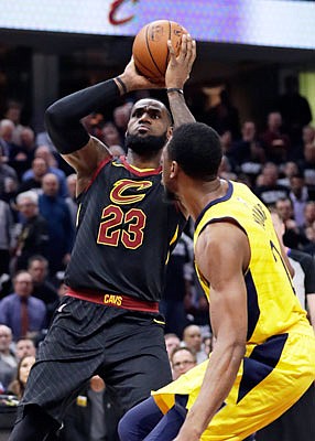 LeBron James of the Cavaliers shoots over Thaddeus Young of the Pacers during Wednesday night's game in Cleveland.