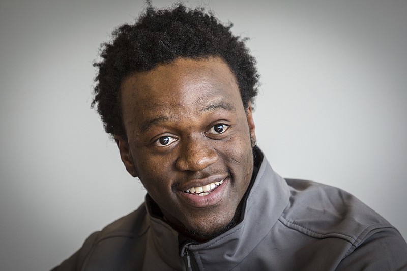 In this April 12, 2018 photo, Allan Monga, 17, a high school student who fled his native Zambia, recites a poem during a news conference in Portland, Maine. Monga, who won the state Poetry Out Loud Contest, is suing the National Endowment for the Arts for not allowing him to compete in the national contest because he has not yet been granted asylum in the United States. (Troy R. Bennett/The Bangor Daily News via AP)