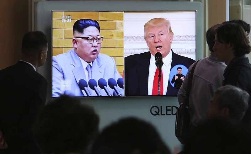 People watch a TV screen showing file footage of U.S. President Donald Trump, right, and North Korean leader Kim Jong Un during a news program at the Seoul Railway Station in Seoul, South Korea, Saturday, April 21, 2018. 