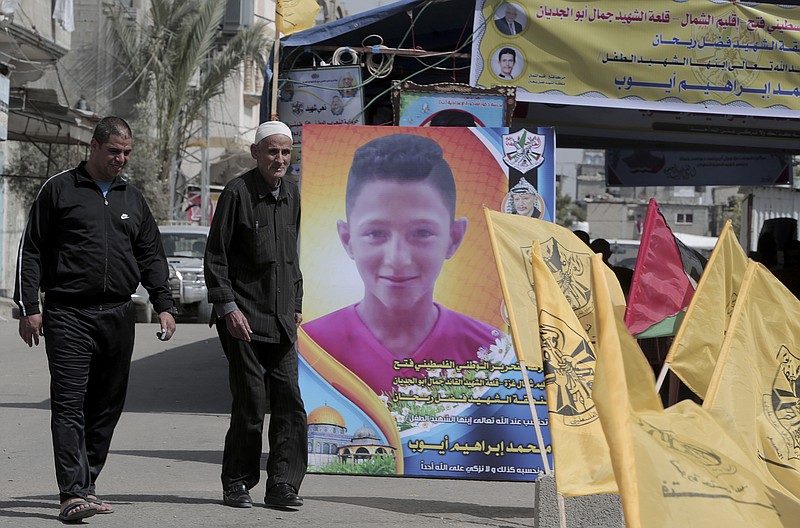 Residents arrive to the house morning of Mohammed Ayyoub, 14, who was killed during a protest along Gaza's border with Israel, east of Jebaliya Yesterday, at the main road in Jebaliya refugee camp, Gaza Strip, Saturday, April 21, 2018. Israel's defense minister said Saturday that Hamas leaders are the "only culprits" in continued bloodshed on the Gaza border, as the EU and a top U.N. official made new demands to investigate shootings of unarmed Palestinians by Israeli soldiers, including the killing of a 14-year-old boy. (AP Photo/Adel Hana)