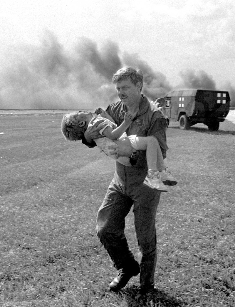 FILE- In this July 19, 1989, file photo, guardsman Dennis Nielsen carries passenger Spencer Bailey away from the wreckage of United Airlines Flight 232 after the plane crashed at Sioux Gateway Airport in Sioux City, Iowa.  Can you fly again? It’s a question facing survivors of this week’s Southwest Airlines accident, which killed one passenger and forced an emergency landing in Philadelphia. (Gary Anderson/Sioux City Journal via AP, File)